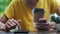 Asian woman holding smartphone sitting outdoors cafe. Portrait of young woman typing mobile phone at coffee break