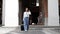 Asian woman holds a travel bag preparing to go to the accommodation and chat on the phone to a friend to meet up for a holiday par