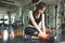 Asian woman injuries during workout at knee in fitness gym sport center. Medical and Healthcare concept. Exercise and Training