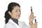 Asian woman laboratory technician examining a tube of blood