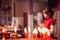 An Asian woman lighting incense sticks to pay homage to the Chinese New Year