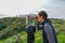 Asian woman looking in the binocular telescope on the tip of the Point Loma Peninsula in San Diego