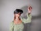 Asian Woman looking through virtual reality device at home. Augmented reality, game, future technology concept.VR