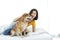 An Asian woman lovingly hugs the Shiba Inu. Dog and girl in the bed room