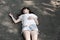 Asian woman lying on the rough cement floor