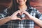 Asian woman making heart hand sign with feeling inlove