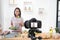 Asian woman making a Vlog video digital camera for her blog cooking