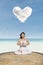 Asian woman meditating at beach under love cloud