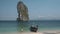 Asian woman mid age on tropical beach in Thailand, tourist walking on a white tropical beach, Railay beach with on the