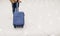 Asian woman passenger holding suitcase in airport terminal,travel concept.