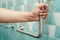 Asian woman patient use toilet support rail in bathroom, handrail safety grab bar, security in nursing hospital