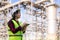 Asian woman petrochemical engineer working with digital tablet Inside oil and gas refinery plant industry factory for inspector