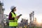 Asian woman petrochemical engineer working with digital tablet Inside oil and gas refinery plant industry factory for inspector