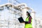 Asian woman petrochemical engineer working at night with laptop Inside oil and gas refinery plant industry factory at night for