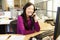 Asian Woman On Phone In Busy Modern Office