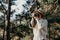 Asian woman photographer enjoys taking pictures with the pine forest nature