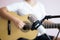 Asian woman play acoustic classic guitar for jazz and easy listening song and record with microphone select focus shallow depth of