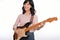 Asian woman playing a vintage sunburst electric guitar  on white background