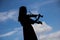 Asian Woman playing violin instrument in Silhouette shape with s