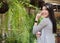 asian woman pose at outdoor cafe. young female adult with natural make-up relax at coffee shop. attractive teenager smile with ha