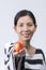 Asian woman poses tomato in hand To communicate about health.