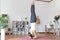 Asian woman practicing hand stand yoga in home