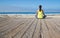 Asian woman practicing yoga at beach