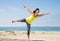 Asian woman practicing yoga at beach