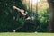 Asian woman practicing yoga in High Lunge, Crescent pose on the mat in outdoor park