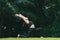 Asian woman practicing yoga in High Lunge, Crescent pose on the mat in outdoor park