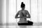 Asian woman practicing yoga with namaste behind the back, sitting in seiza exercise vajrasana pose, rear view, ,monochrome