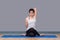 Asian woman practicing yoga pose at sport gym