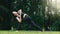 Asian woman practicing yoga in Prep Poses for Side Crane Pose for Parsva Bakasana on the mat in outdoor park