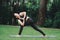 Asian woman practicing yoga in Prep Poses for Side Crane Pose for Parsva Bakasana on the mat in outdoor park