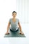 Asian woman practicing yoga , stretching in Cobra exercise, Bhujangasana pose, working out, indoor
