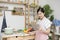 Asian woman prepare cook in kitchen hand hold smart tablet learn how to cook by her own