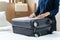 Asian woman preparing packing suitcase getting ready for travel