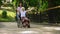 Asian woman pushing excited mature lady wheelchair, happy aged patient, health