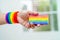 Asian woman with rainbow flag, LGBT symbol rights and gender equality, LGBT Pride Month in June, LGBTQ, LGBTI, LGBTQA, LGBTQIA