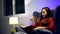 Asian woman reading book in living room at night. Lifestyle and relaxing