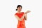 Asian woman in red cheongsam costume holding plate of teas. Chinese new year concept style