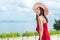Asian woman in red dress enjoys her vacation in sunny day