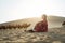 Asian woman in red dress looking at view in desert