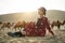 Asian woman in red dress looking at view in desert