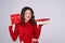 Asian woman in red warm clothes with gifts. Holidays New Year and Christmas