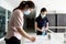 Asian woman is registering for check-in,registration book before entering the building,child girl is cleaning her hands with hand