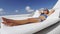 Asian woman relaxing lounging on white outdoor beach sofa daybed