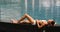 Asian woman relaxing sunbathing - pool spa health retreat body care