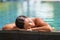 Asian woman relaxing sunbathing - pool spa retreat