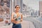 Asian woman running and doing fitness exercises on the Dubai Marina embankment and listening to music with headphones and